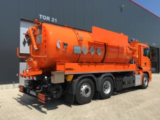 Orange KROLL vacuum truck on a three-axle chassis, rear view in front of the KROLL hall