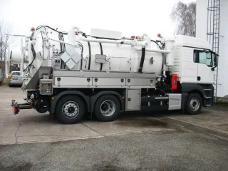 White vacuum truck with stainless steel toolboxes, side view
