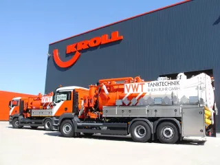 Tank cleaning vehicle with multi-compartment body in front of the KROLL plant, a second vehicle behind it